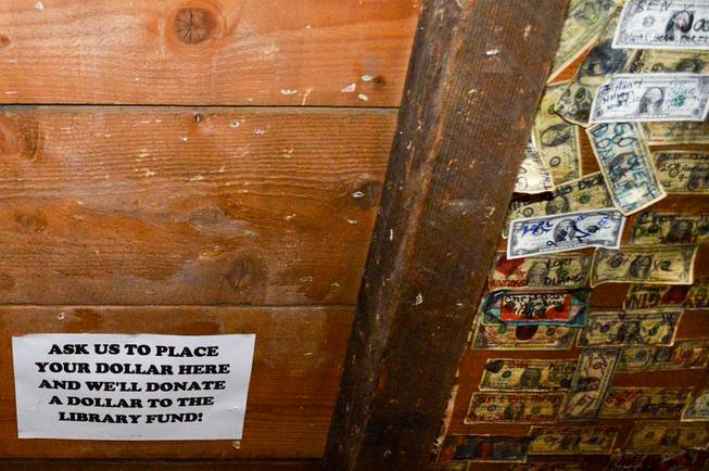 The ceiling of the bar in the Gold Hill Hotel, the oldest in the state, is usually filled with dollar bills. Late in 2013, hotel manager Clay Mitchell cleared part of the ceiling to collect money for the effort to open a new library in Virginia City.